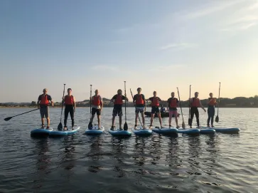 Students standing on paddle boards at ASC Birmingham