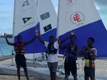 Excited youths waving at ASC Turks and Caicos