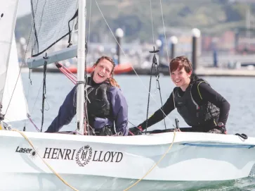 Two people sailing a Laser dinghy