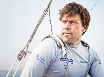 Andrew Simpson looking at the sea past some rigging